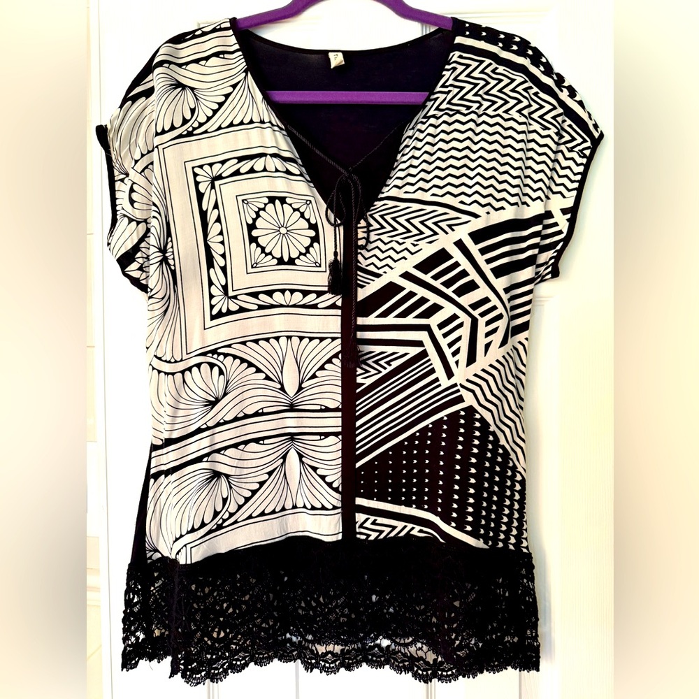 Asian-inspired print, rayon shirt with crotchet trim. Cord tie at the neck.